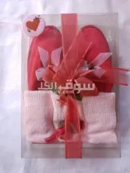 Red slippers with flower and towel
